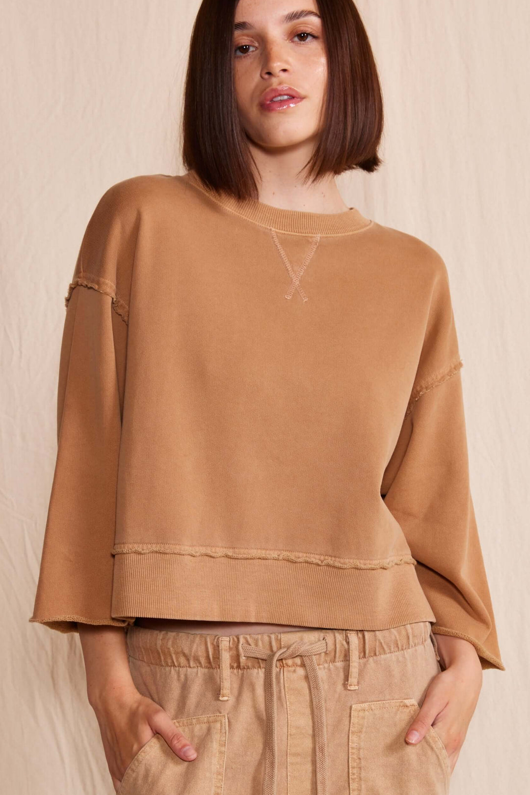 Elevate your wardrobe with the People of Leisure Dana Top made in USA, a masterpiece of sustainable elegance. Made from 100% organic cotton, this long-sleeve shirt embodies ethical fashion and luxurious comfort.