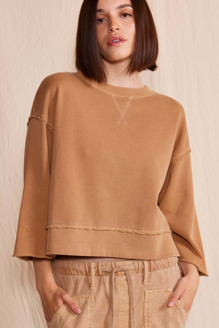 Elevate your wardrobe with the People of Leisure Dana Top made in USA, a masterpiece of sustainable elegance. Made from 100% organic cotton, this long-sleeve shirt embodies ethical fashion and luxurious comfort.