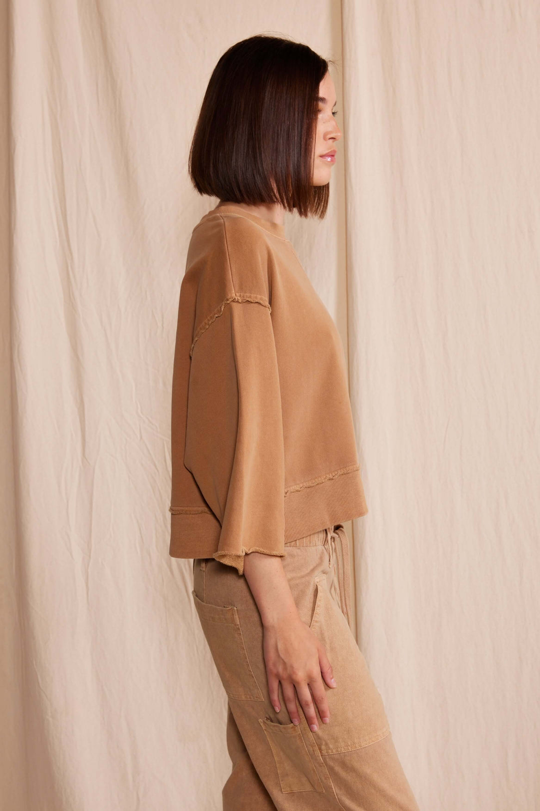 Elevate your wardrobe with the People of Leisure Dana Top made in USA, a masterpiece of sustainable elegance. Made from 100% organic cotton, this long-sleeve shirt embodies ethical fashion and luxurious comfort.