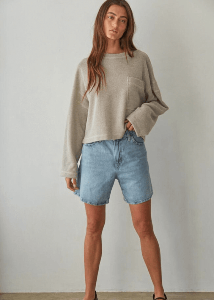 Embrace cozy elegance with this American made Perfect Fall Sweater in Taupe. Featuring a soft knit Hacci fabric and a flattering round neck, its medium length and loose fit offer comfort without sacrificing style.
