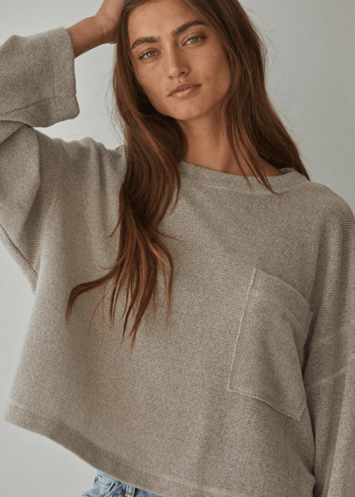 Embrace cozy elegance with this American made Perfect Fall Sweater in Taupe. Featuring a soft knit Hacci fabric and a flattering round neck, its medium length and loose fit offer comfort without sacrificing style.