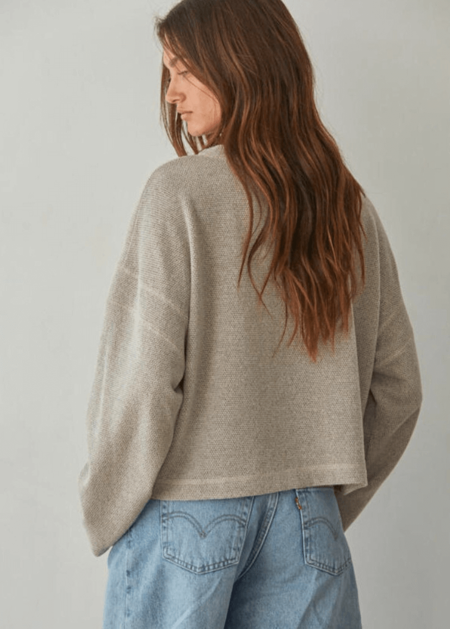 Embrace cozy elegance with this American made Perfect Fall Sweater in Taupe. Featuring a soft knit Hacci fabric and a flattering round neck, its medium length and loose fit offer comfort without sacrificing style.