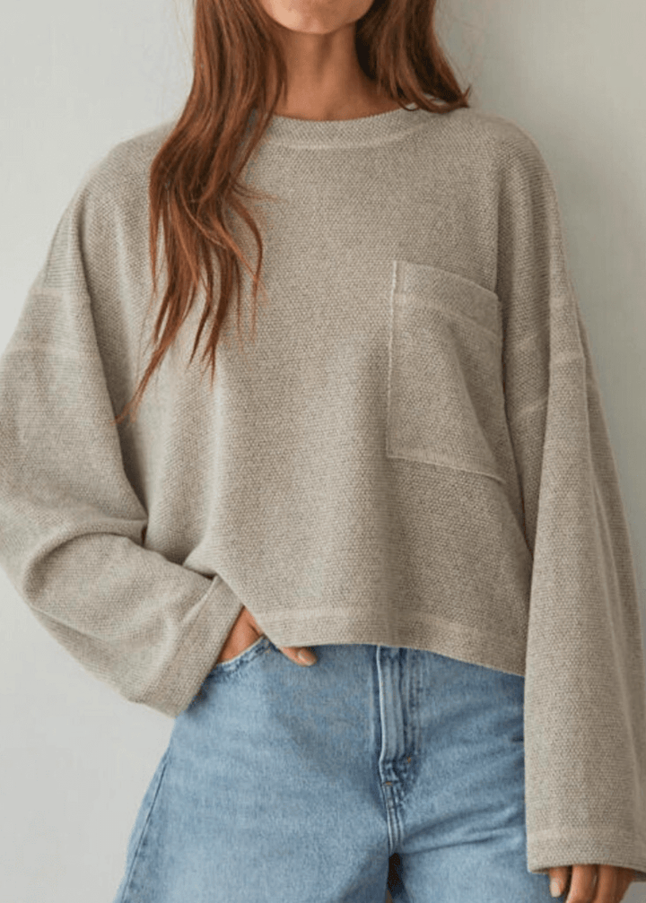 Embrace cozy elegance with this American made Perfect Fall Sweater in Taupe. Featuring a soft knit Hacci fabric and a flattering round neck, its medium length and loose fit offer comfort without sacrificing style.