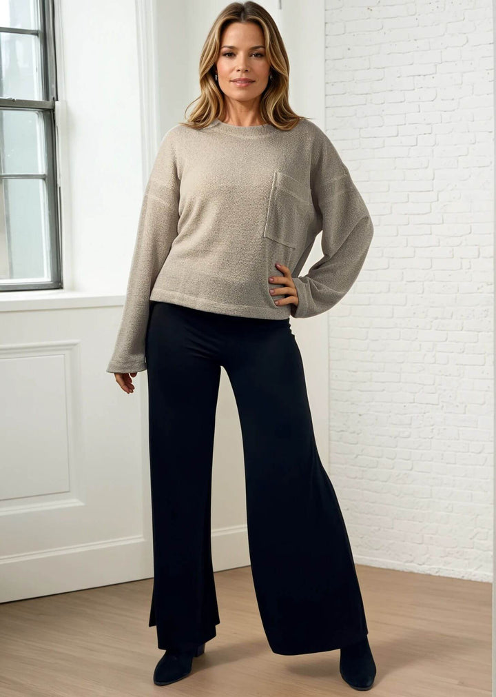 Experience ultimate comfort and style with these Soft Rayon Jersey Palazzo Pants in Solid Black, crafted in the USA. Featuring a flattering fold-over waist and a wide-leg silhouette, they offer a relaxed yet chic look. Made from a stretchy blend of rayon and spandex, these pants move with you while maintaining their softness.