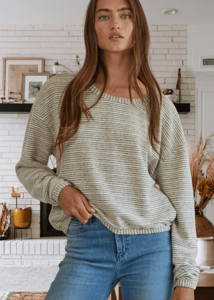 Embrace effortless comfort with the Cara Pullover, a soft and cozy sweater designed for everyday wear. Featuring a relaxed loose fit and round neckline, this just-below-waist-length top transitions seamlessly from casual to polished.  This Made in USA Ivory and Gray sweater is perfect for layering or wearing solo.