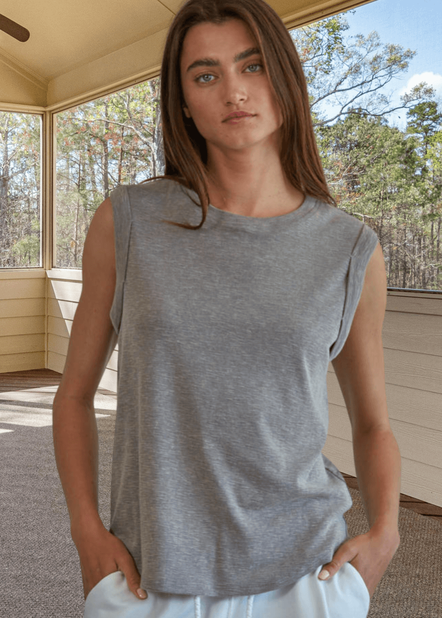 Effortlessly chic and undeniably comfortable, this made in USA women's cotton muscle tee delivers laid-back style with everyday versatility. Crafted from a breathable 75% cotton and 25% polyester blend, it features a classic round neckline and signature rolled muscle sleeves that frame the shoulders beautifully. 