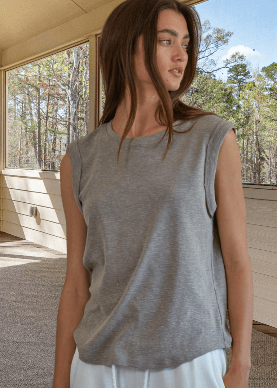Effortlessly chic and undeniably comfortable, this made in USA women's cotton muscle tee delivers laid-back style with everyday versatility. Crafted from a breathable 75% cotton and 25% polyester blend, it features a classic round neckline and signature rolled muscle sleeves that frame the shoulders beautifully. 