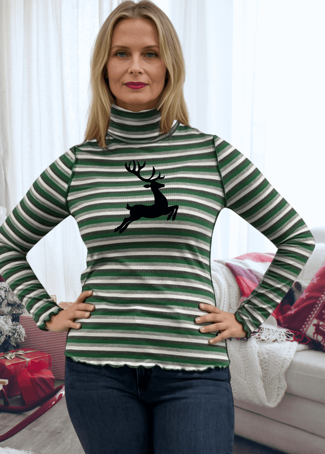 Bring holiday cheer to your wardrobe with this whimsical reindeer turtleneck! Featuring a delightful graphic paired with bold stripes in festive red or green, this lightweight ribbed knit top keeps things fun and cozy. The mock turtleneck and semi-fitted cut offer a flattering everyday look, while playful lettuce merrow stitching at the cuffs and hem adds personality