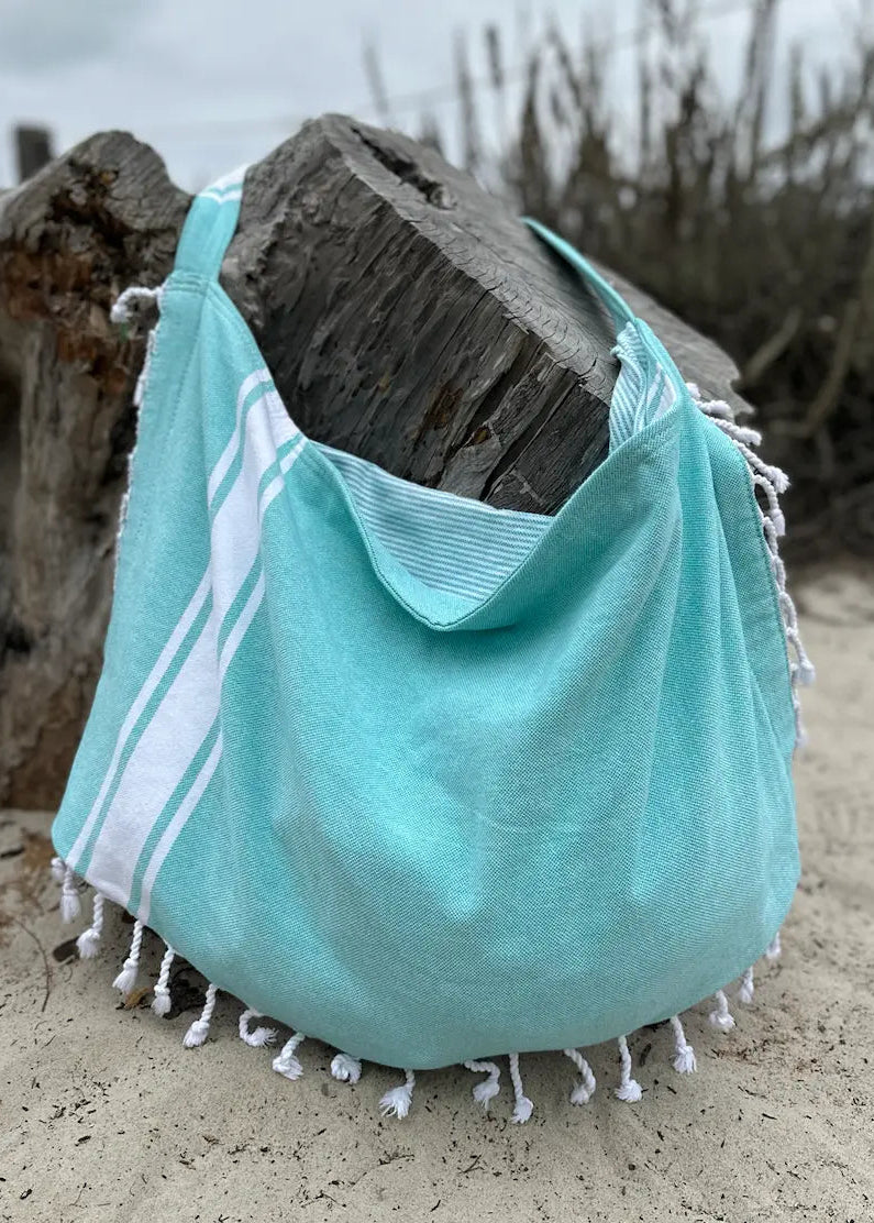 Shop the Beachables Solid 3-in-1 Turkish Cotton Beach Bag – converts from bag to towel to chair cover. Sand-resistant, quick-dry, machine washable. Made in USA.