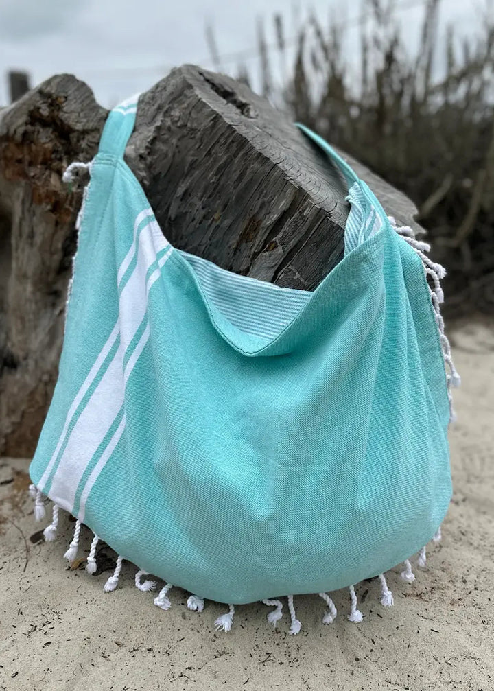 Shop the Beachables Solid 3-in-1 Turkish Cotton Beach Bag – converts from bag to towel to chair cover. Sand-resistant, quick-dry, machine washable. Made in USA.