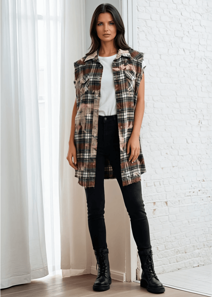 Meet The Sedona Sunset Sleeveless Plaid Flannel Tunic - a sleeveless, boho-chic essential designed for effortless layering and laid-back luxury. Crafted in Los Angeles from ultra-soft, vintage-washed plaid, this one-of-a-kind piece features hand-bleached details, raw frayed edges, and classic chest pockets for a relaxed yet elevated vibe. Its tunic length makes it versatile enough to wear open over denim shorts or buttoned up as a dress.