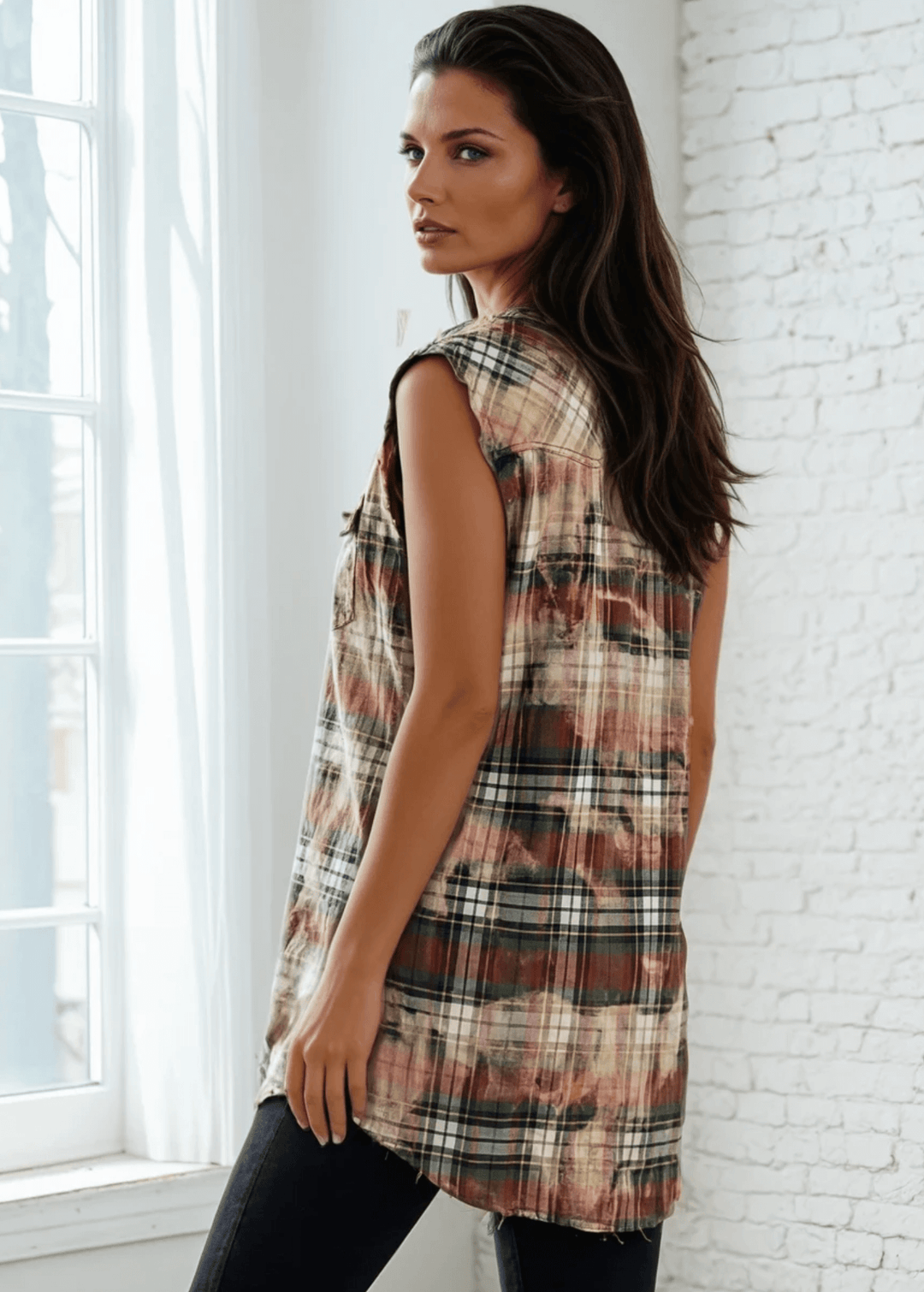 Meet The Sedona Sunset Sleeveless Plaid Flannel Tunic - a sleeveless, boho-chic essential designed for effortless layering and laid-back luxury. Crafted in Los Angeles from ultra-soft, vintage-washed plaid, this one-of-a-kind piece features hand-bleached details, raw frayed edges, and classic chest pockets for a relaxed yet elevated vibe. Its tunic length makes it versatile enough to wear open over denim shorts or buttoned up as a dress.