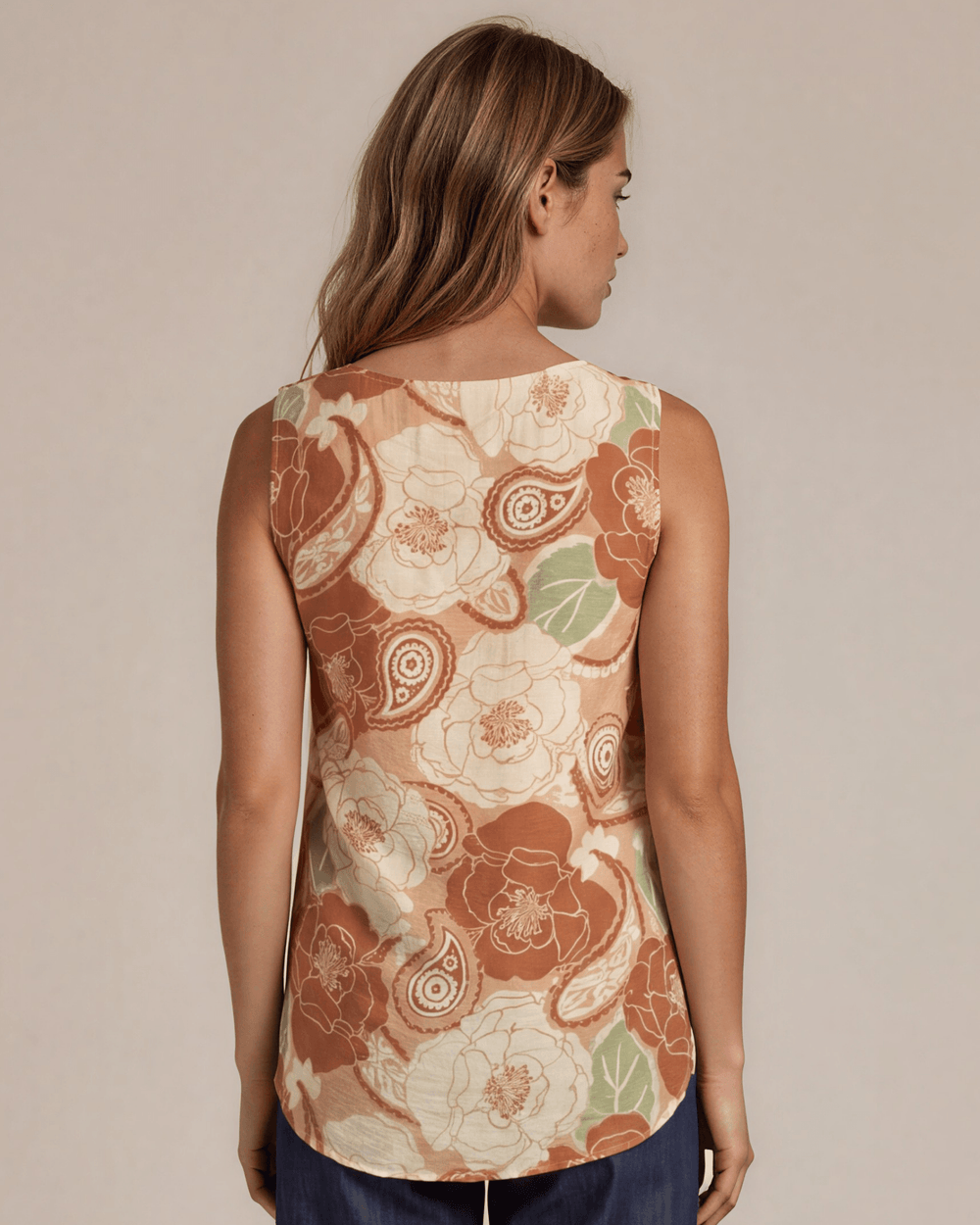Sleeveless boat neck top in a rust floral paisley print. Hammered satin look, Rayon Linen Blend Fabric, longer in back. Made in USA.