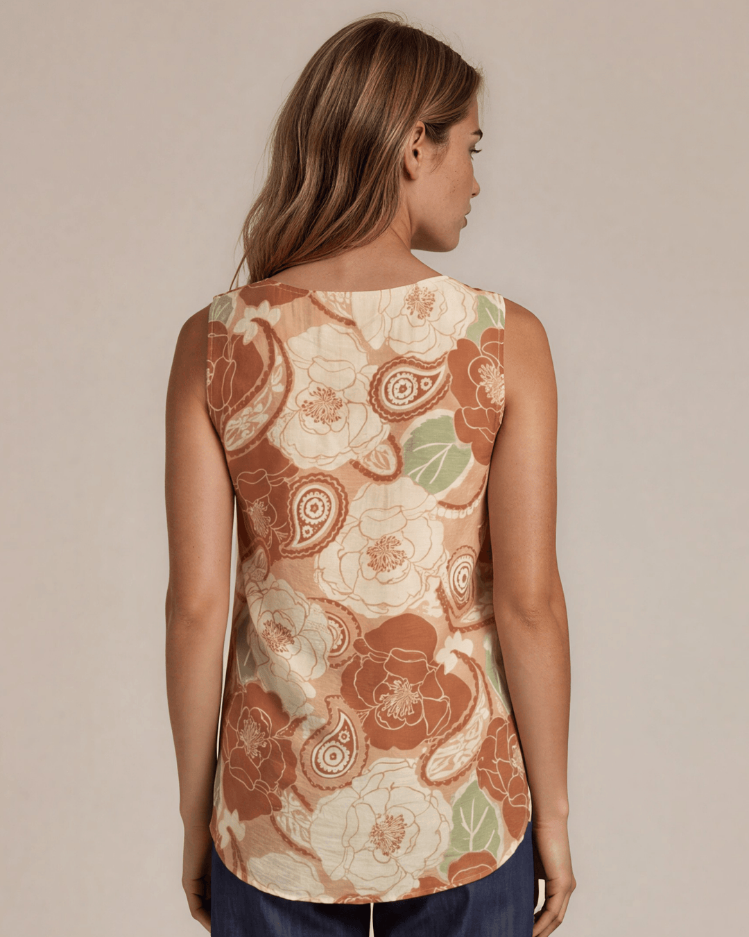 Sleeveless boat neck top in a rust floral paisley print. Hammered satin look, Rayon Linen Blend Fabric, longer in back. Made in USA.