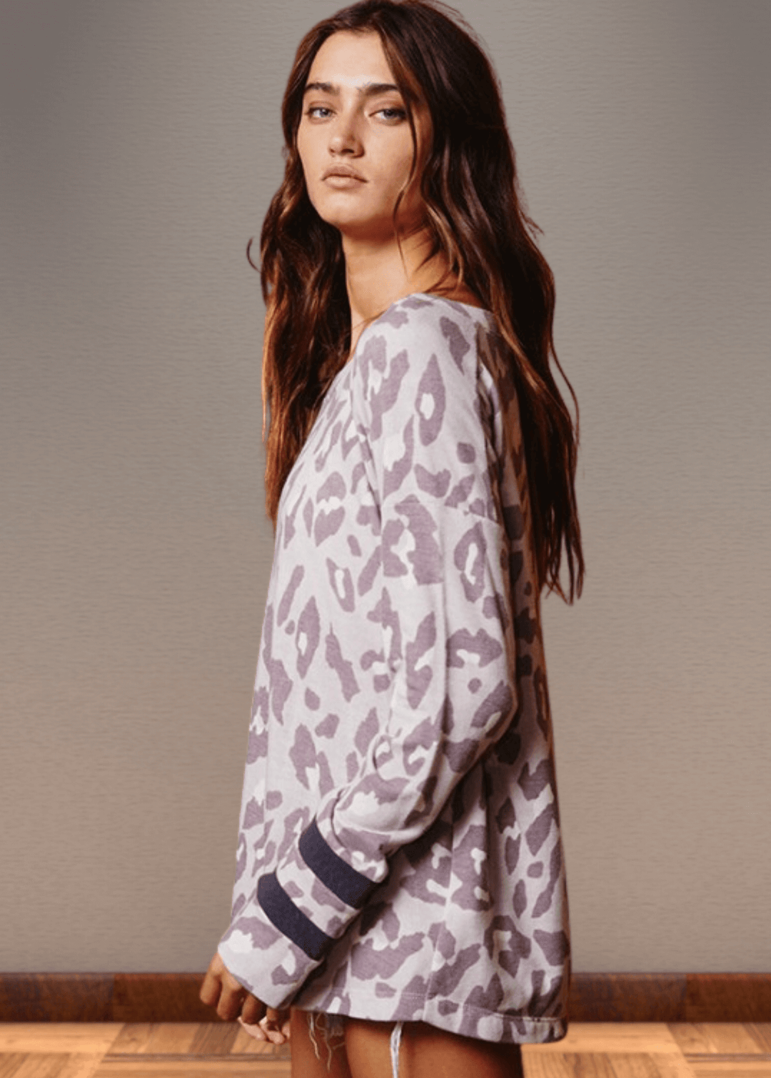 Experience effortless style with the Dusty Lavender Animal Print Top. Its wide round neckline and relaxed fit provide comfort without compromising on fashion.  Bucket List Style T1100