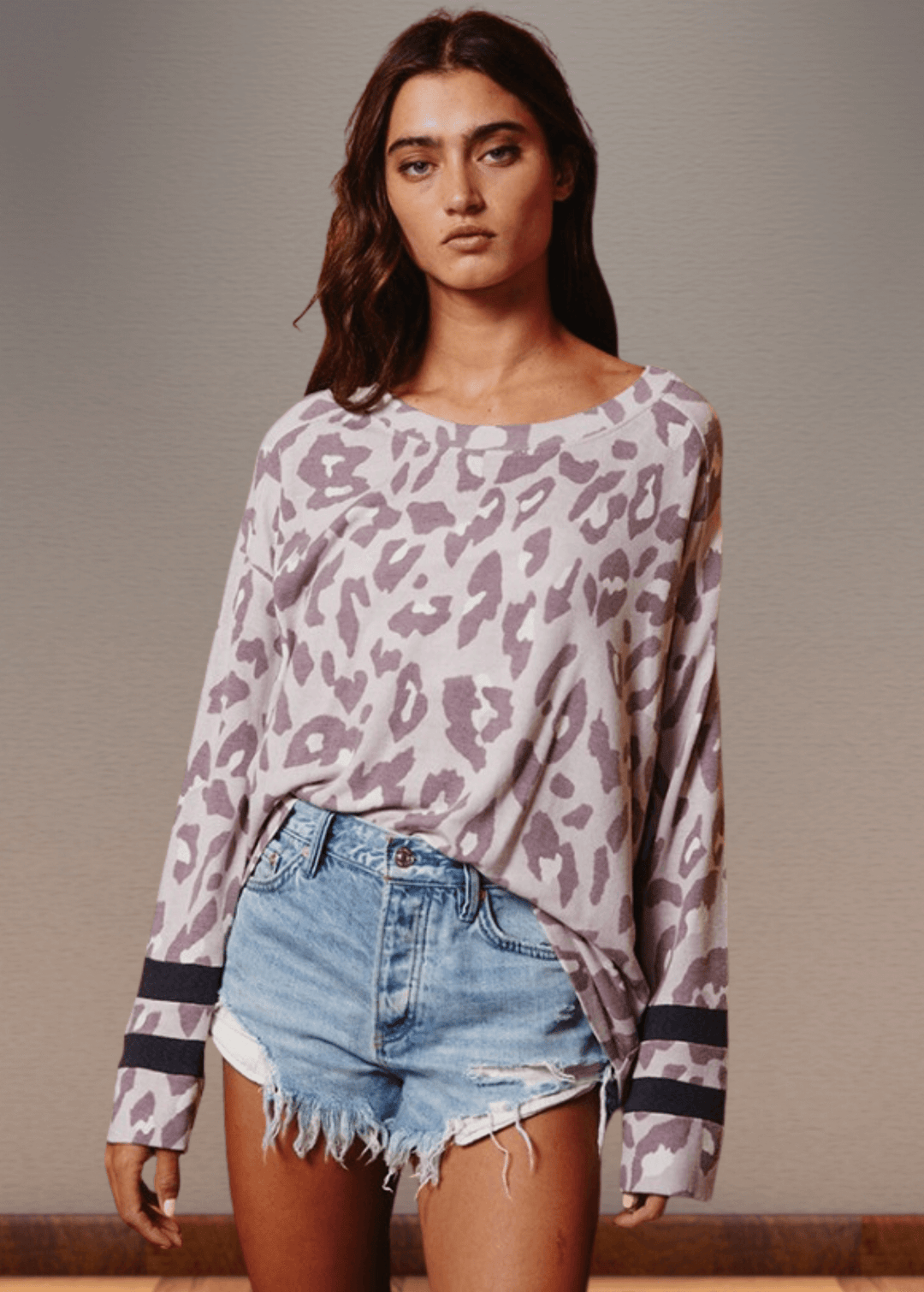 Experience effortless style with the Dusty Lavender Animal Print Top. Its wide round neckline and relaxed fit provide comfort without compromising on fashion.  Bucket List Style T1100