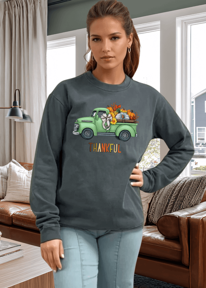 Cozy up in gratitude with this heavyweight pigment-dyed cotton sweatshirt featuring a charming vintage green truck graphic and the colorful word "Thankful". Crafted in the USA from 100% cotton, this piece delivers the durability and comfort you'll love wearing season after season.