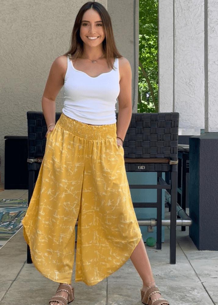 Made in USA Women's Fun Yellow Printed Smocked Waist Pants with Pockets and Asymmetrical Cropped Hem | Brand: Bucket List Style P5024  | Made in USA 
