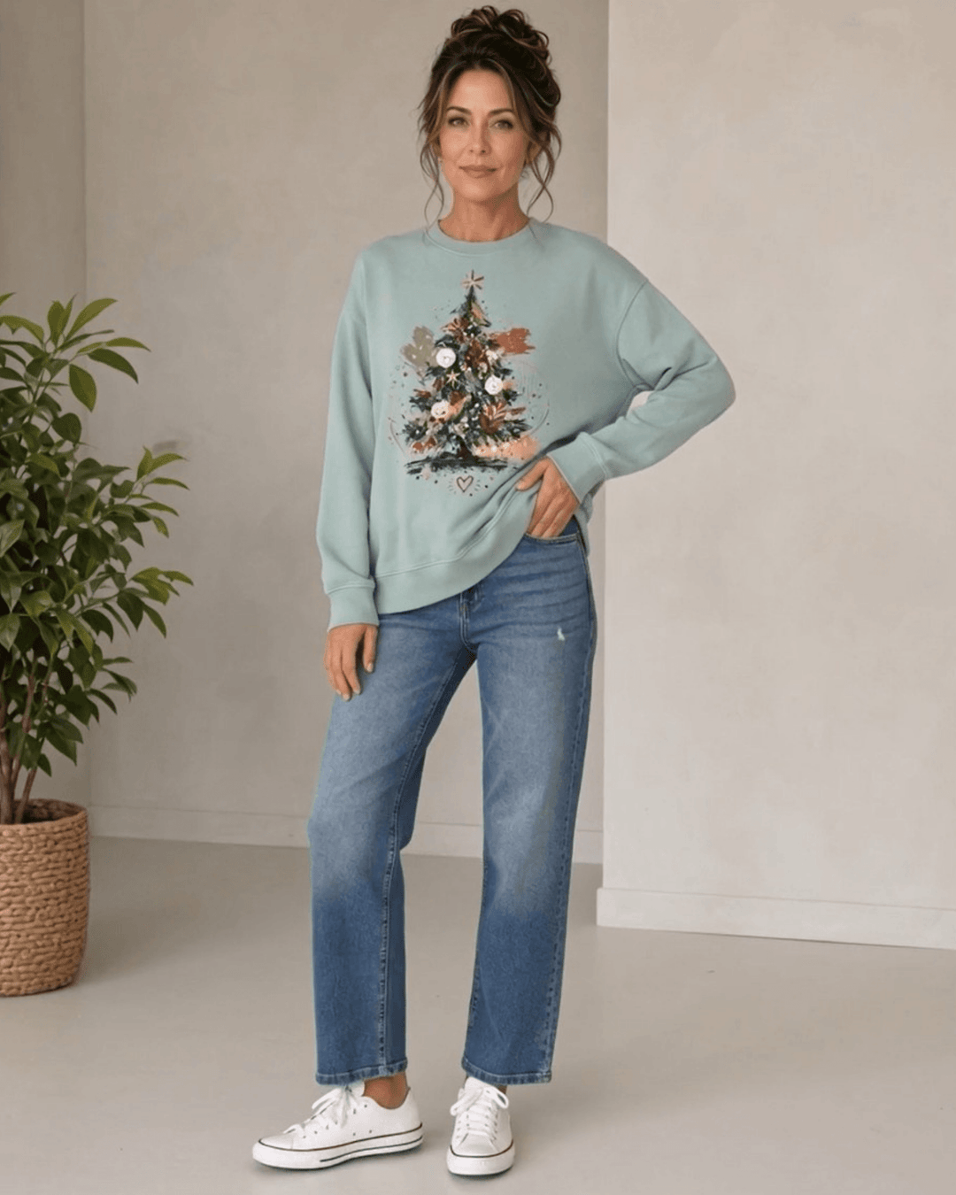 Made in USA Abstract Art Christmas Tree crew neck sweatshirt in sage green with a painterly abstract art Christmas tree graphic, front full-length view on female model with jeans