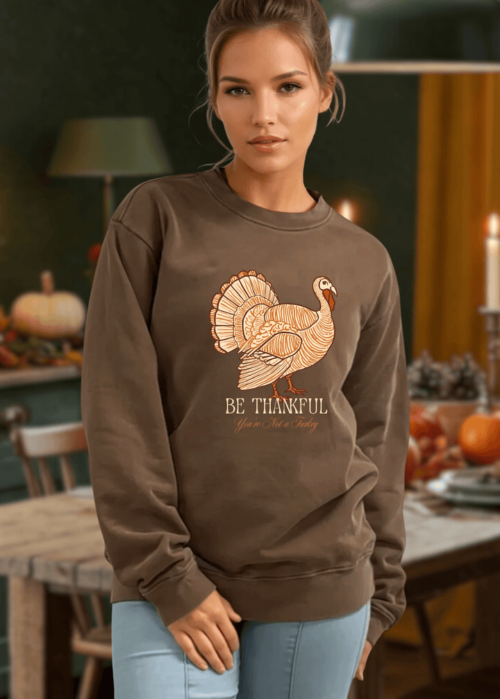 Stay cozy and stylish this Thanksgiving with the Made in USA Be Thankful Turkey Graphic Heavy Cotton Fleece Sweatshirt. Crafted from 100% heavyweight USA cotton in Mocha