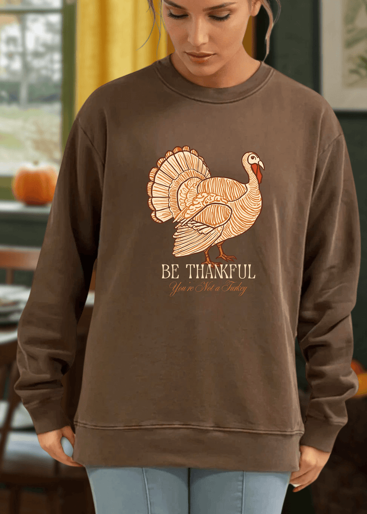 Stay cozy and stylish this Thanksgiving with the Made in USA Be Thankful Turkey Graphic Heavy Cotton Fleece Sweatshirt. Crafted from 100% heavyweight USA cotton in Mocha