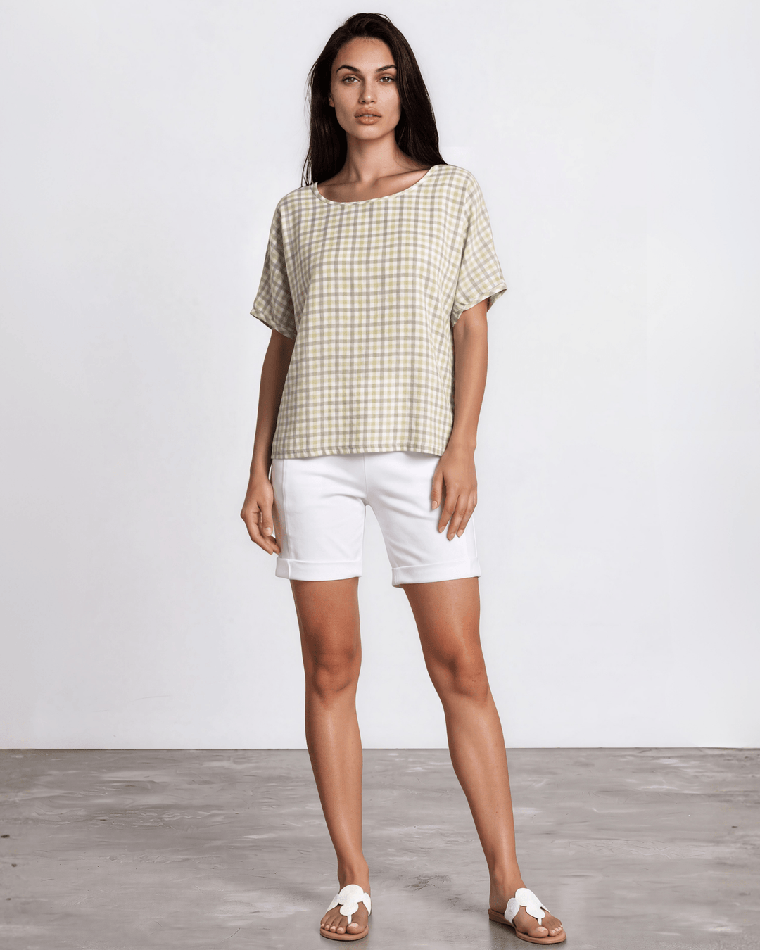 Sage green woven checkered plaid short sleeve top with a wide scoop neckline, rolled cuffs, and a relaxed boxy fit in lightweight 100% rayon. Made in USA.