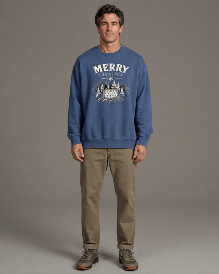 Made in USA Merry Christmas Faith Family Freedom crew neck sweatshirt in denim blue with a Merry Christmas Faith Family Freedom mountain graphic, front full-length view on male model with khaki pants