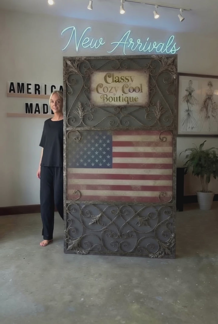 "Black two-piece loungewear set featuring a relaxed-fit short-sleeve crew neck tee with a chest pocket and wide-leg pants with split hems and an elastic waistband, in a soft stretch fabric blend. Made in USA."