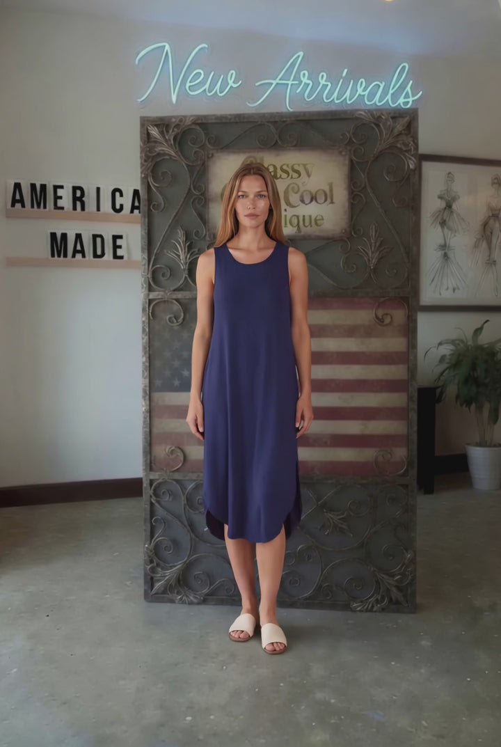 Sammie Sleeveless Midi Dress in navy blue. Relaxed fit, scoop neck, side pockets &amp; slits. 95% Rayon, 5% Spandex. Made in USA.