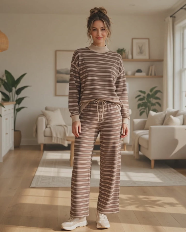 Model wearing the Striking Stripes brown and taupe striped mock neck top with matching ankle length drawstring pants in a living room, Made in USA