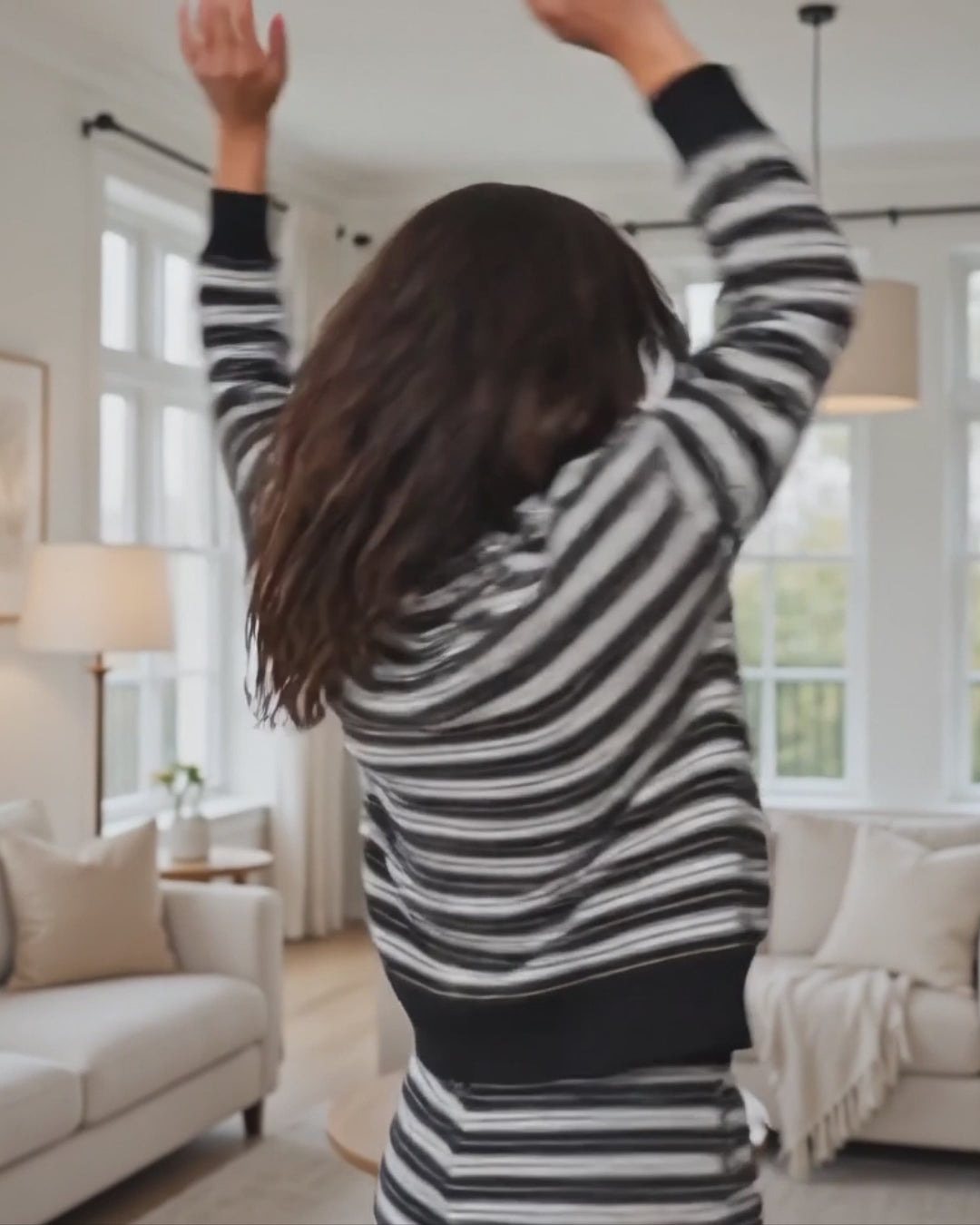 Model wearing the Striking Stripes black and gray striped mock neck top with matching drawstring shorts, Made in USA