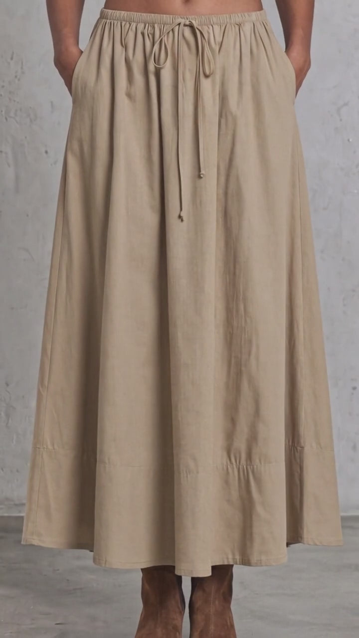Made in USA. Discover a khaki 100% cotton poplin maxi skirt with a gathered drawstring waist and graceful, flowy silhouette. Sizes S–L.