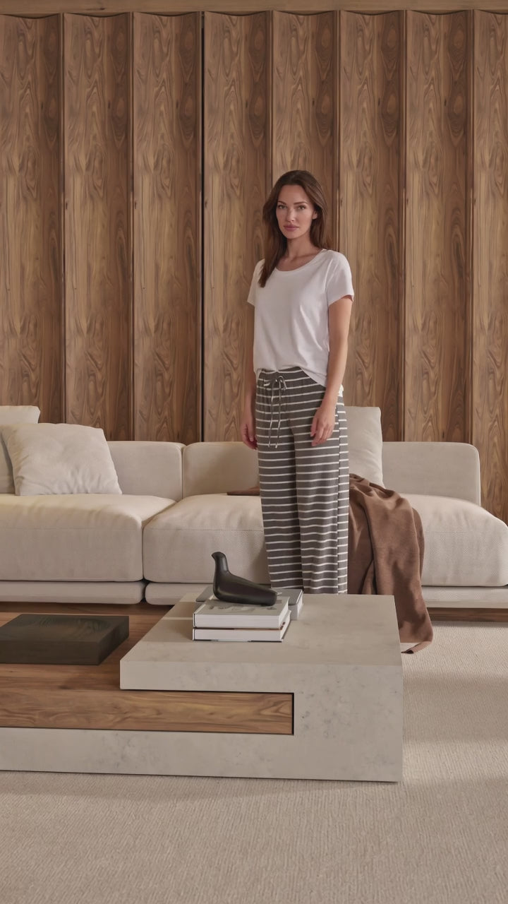 Made in USA. Relax in charcoal striped wide-leg pajama pants with an elastic drawstring waist, side pockets and soft stretch fabric. Sizes S–XL.