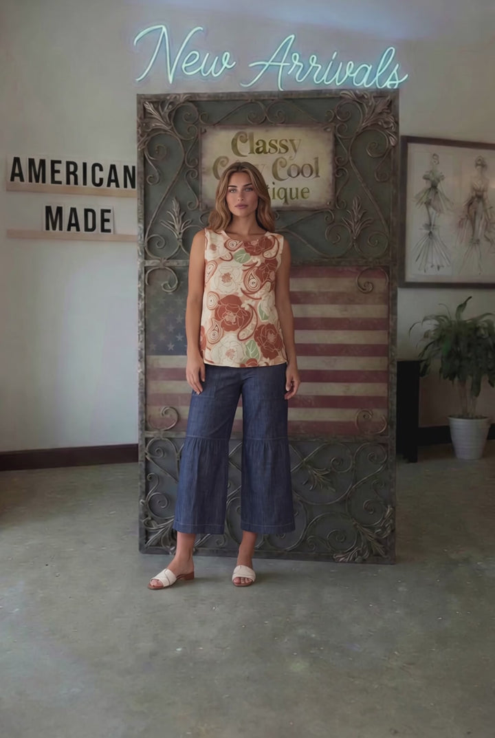 Sleeveless boat neck top in a rust floral paisley print. Hammered satin look, Rayon Linen Blend Fabric, longer in back. Made in USA.