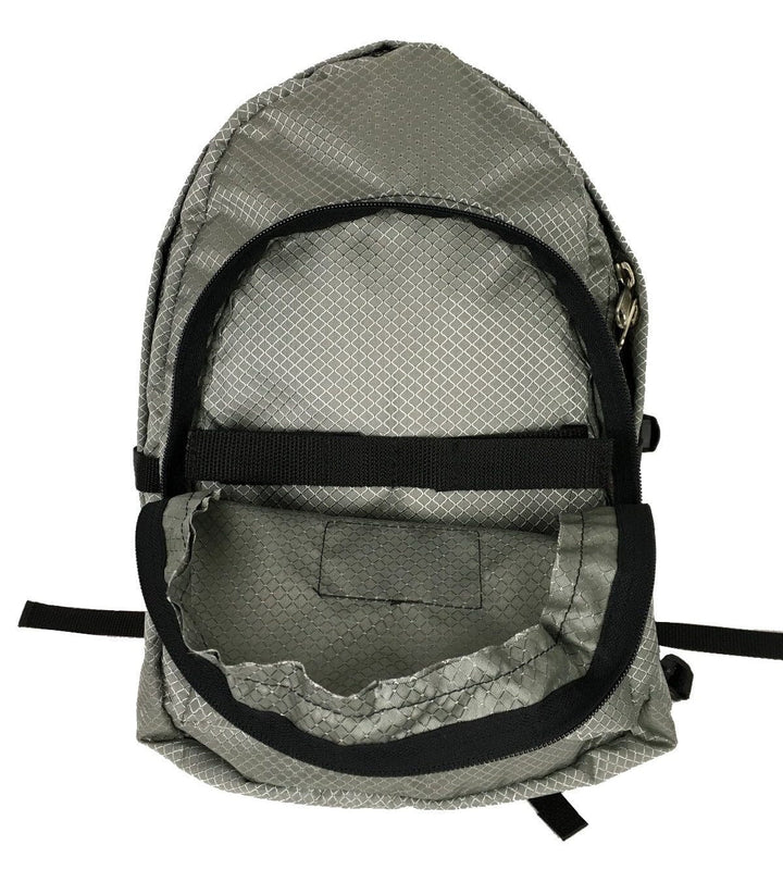 Made in USA, open silver diamond diaper bag backpack showing roomy main compartment and diamond-pattern lining