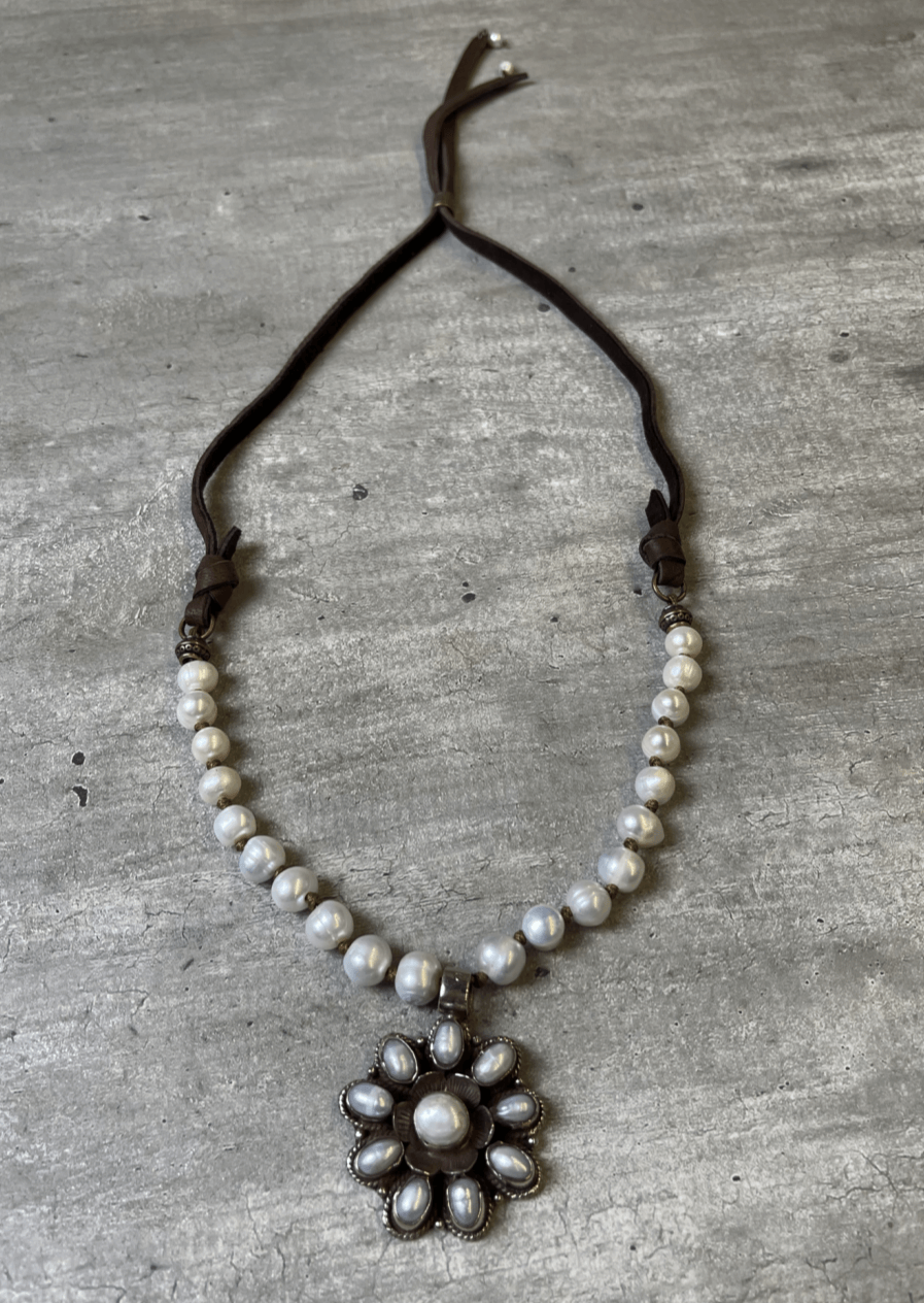 This handcrafted flower statement pendant is unique & stunning with an array of freshwater pearls. Handcrafted in Texas, USA!  Classy Cozy Cool Boutique.