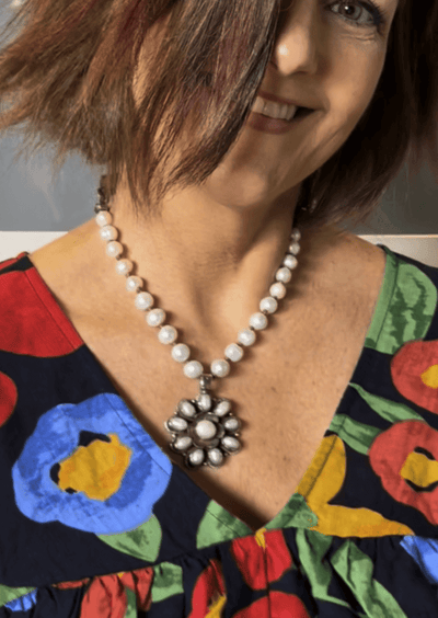 This handcrafted flower statement pendant is unique & stunning with an array of freshwater pearls. Handcrafted in Texas, USA!  Classy Cozy Cool Boutique.