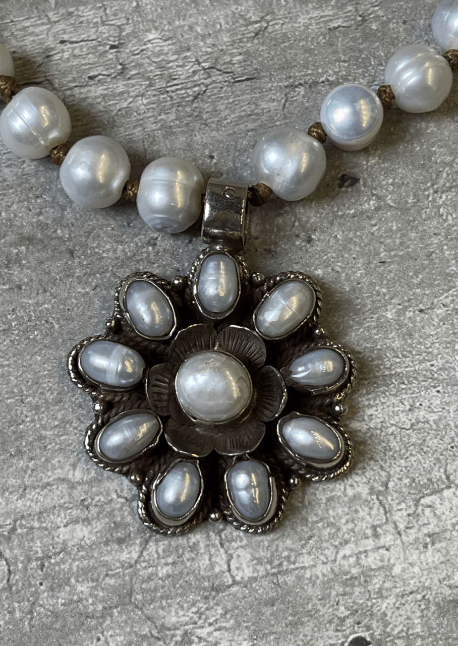 This handcrafted flower statement pendant is unique & stunning with an array of freshwater pearls. Handcrafted in Texas, USA!  Classy Cozy Cool Boutique.
